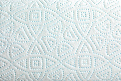 Toilet paper with pattern as background, closeup