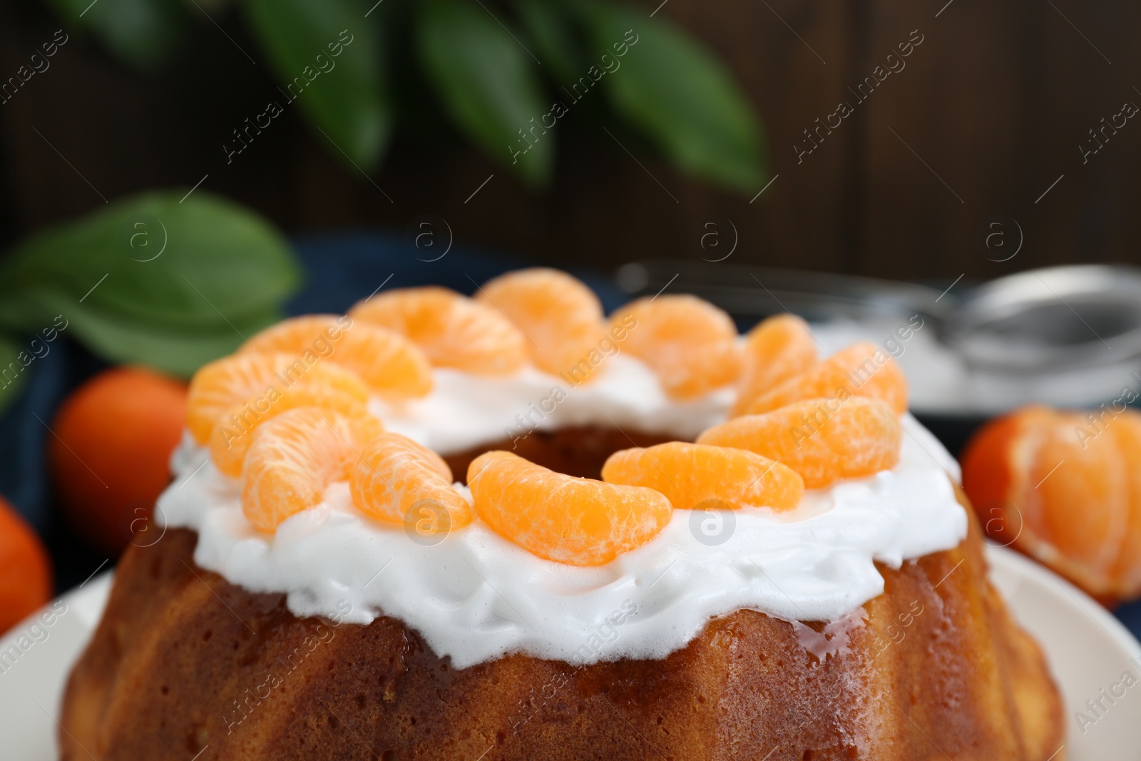 Photo of Homemade yogurt cake with tangerines and cream, closeup