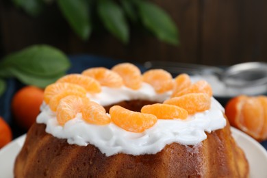 Photo of Homemade yogurt cake with tangerines and cream, closeup