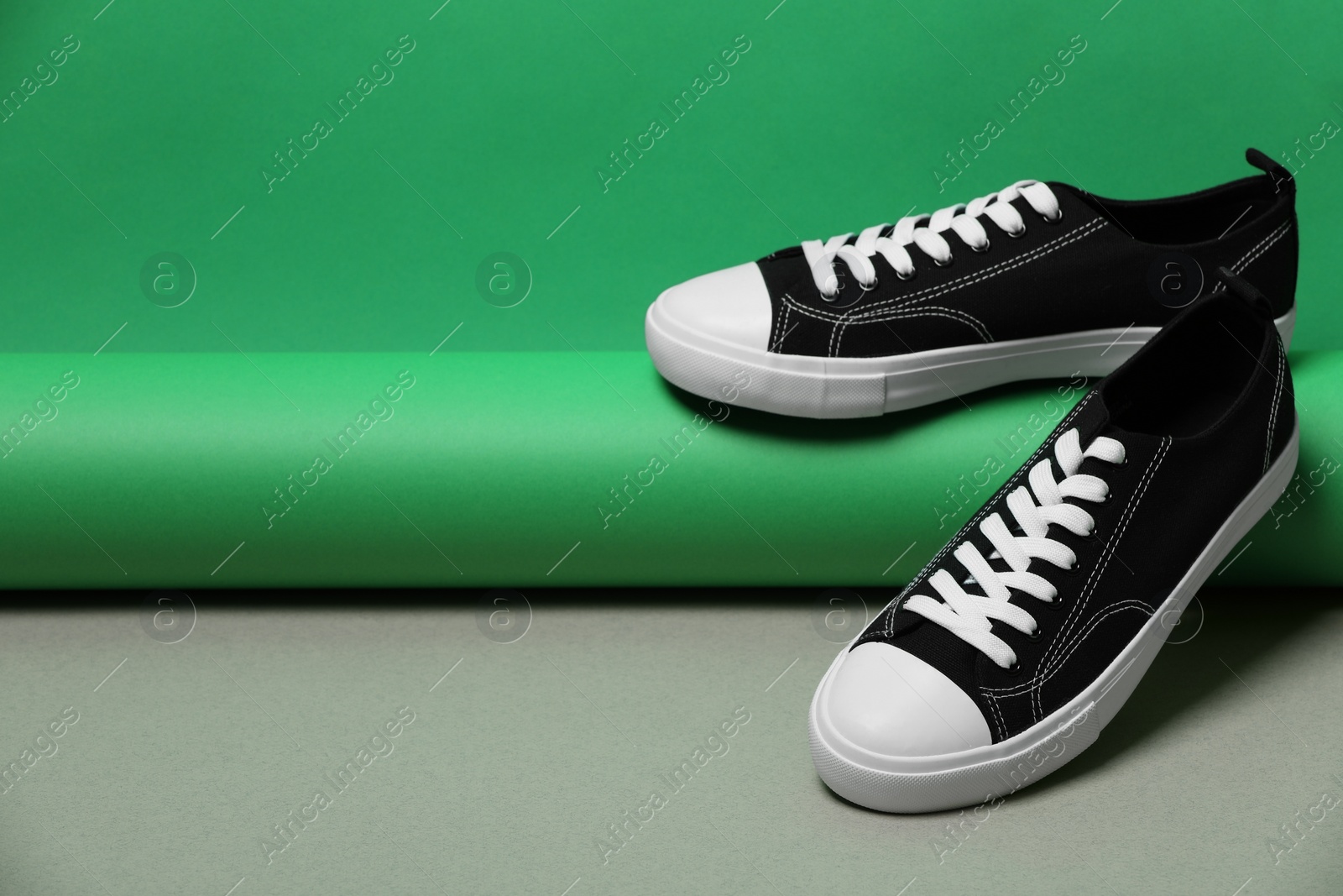 Photo of Pair of stylish sneakers on color background, space for text