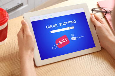 Image of Woman using tablet for online shopping indoors, closeup