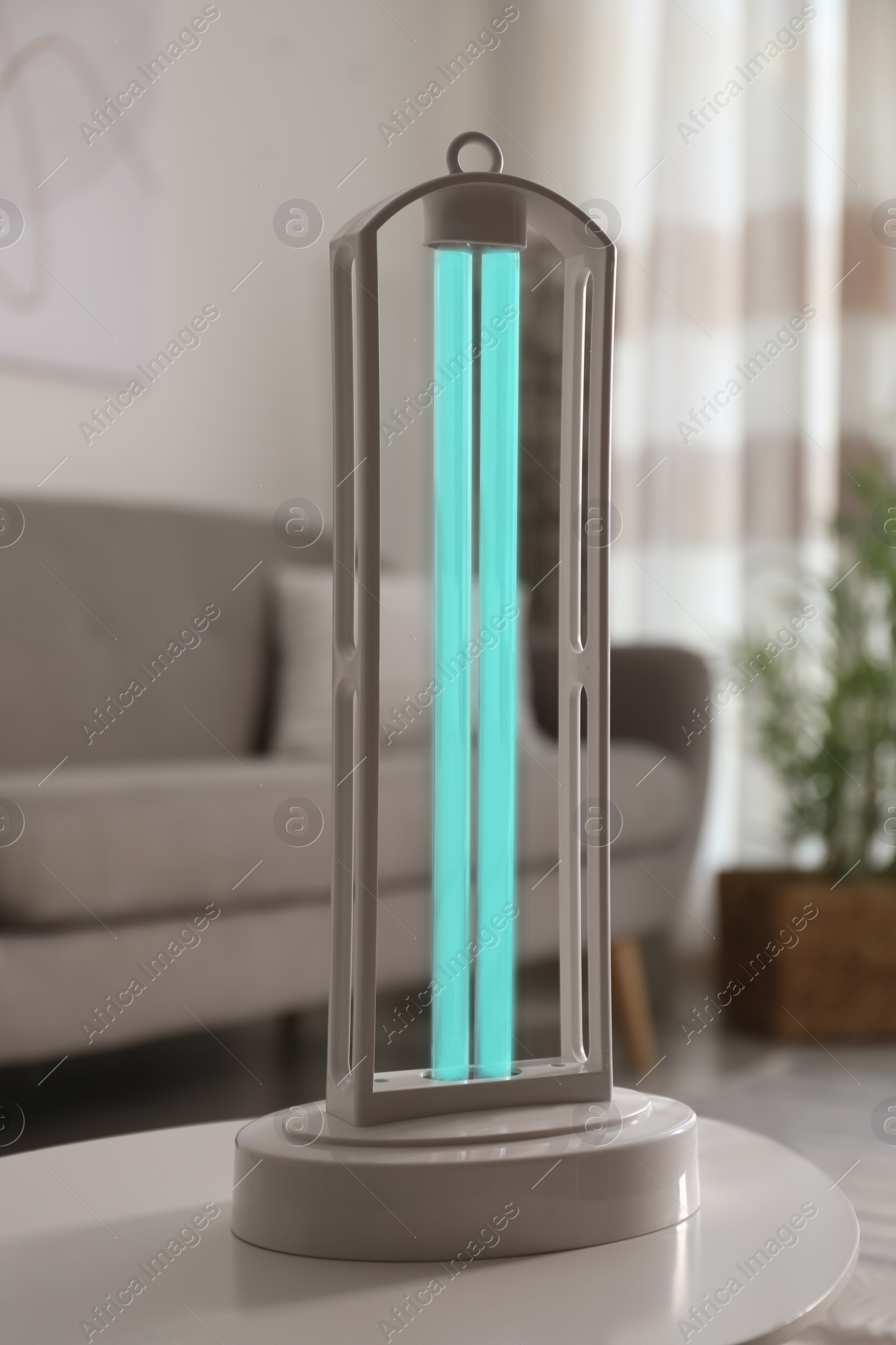 Photo of UV lamp for light sterilization on table in living room