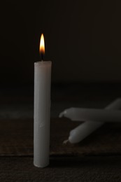 Church wax candles on dark background, space for text