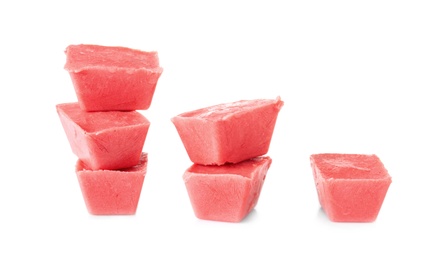 Tasty berry ice cubes on white background