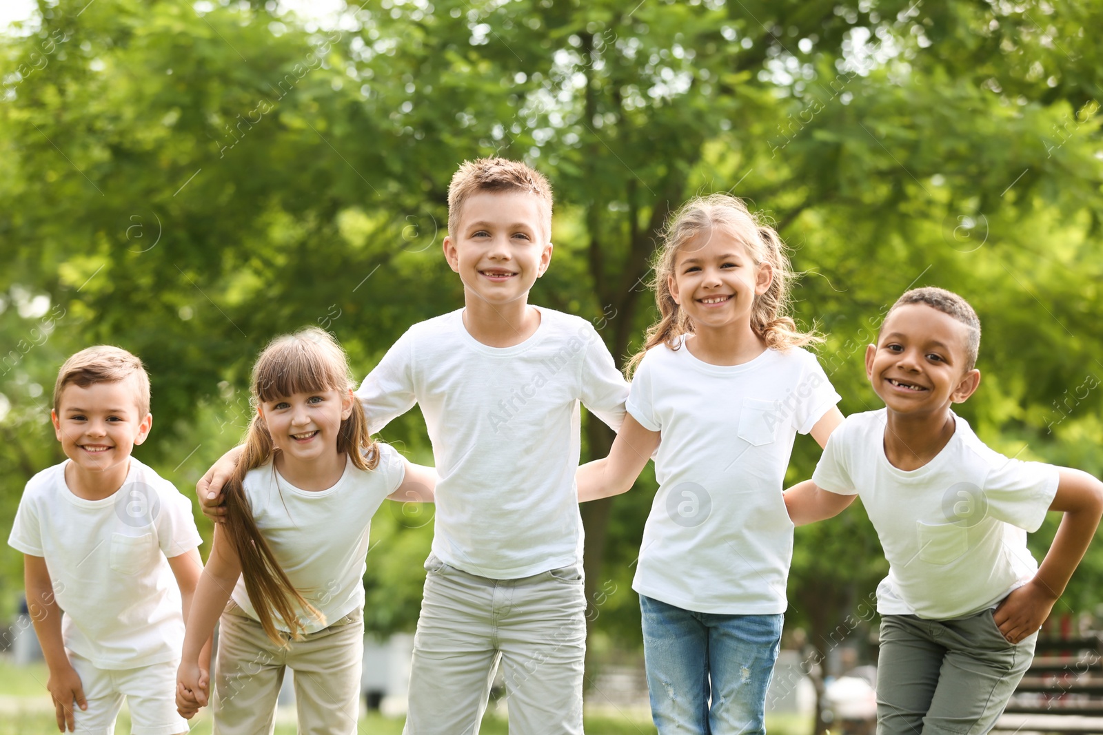 Photo of Group of children huddling in park. Volunteer project