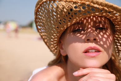 Beautiful woman with straw hat outdoors on sunny day, space for text