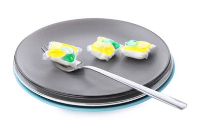 Photo of Dishware with dishwasher detergent pods on white background