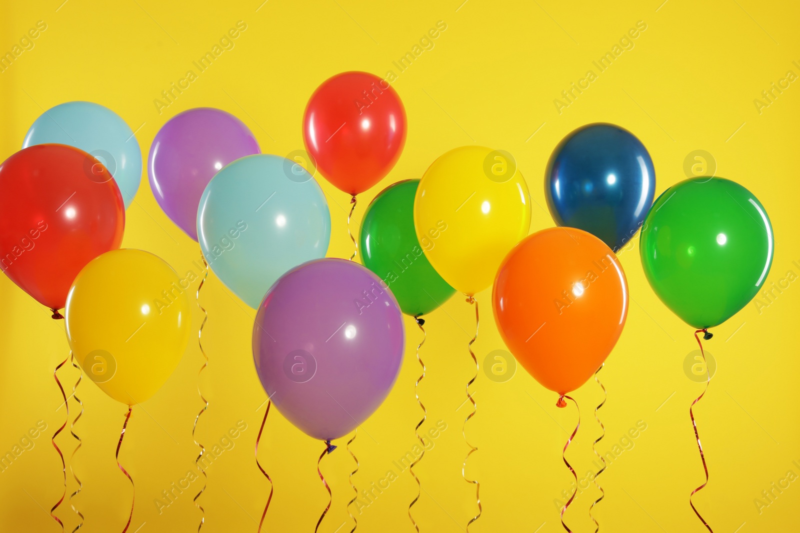 Photo of Bright balloons on color background. Celebration time