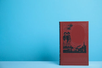 Photo of Hardcover book on blue background. Space for design