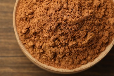 Aromatic cinnamon powder on table, top view