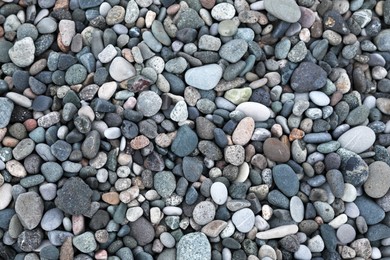 Many different pebbles as background, top view