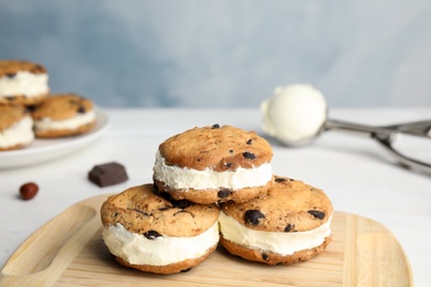 Photo of Sweet delicious ice cream cookie sandwiches on table