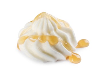 Delicious fresh whipped cream with caramel sauce isolated on white