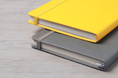 Photo of Stylish notebooks on white wooden table, closeup