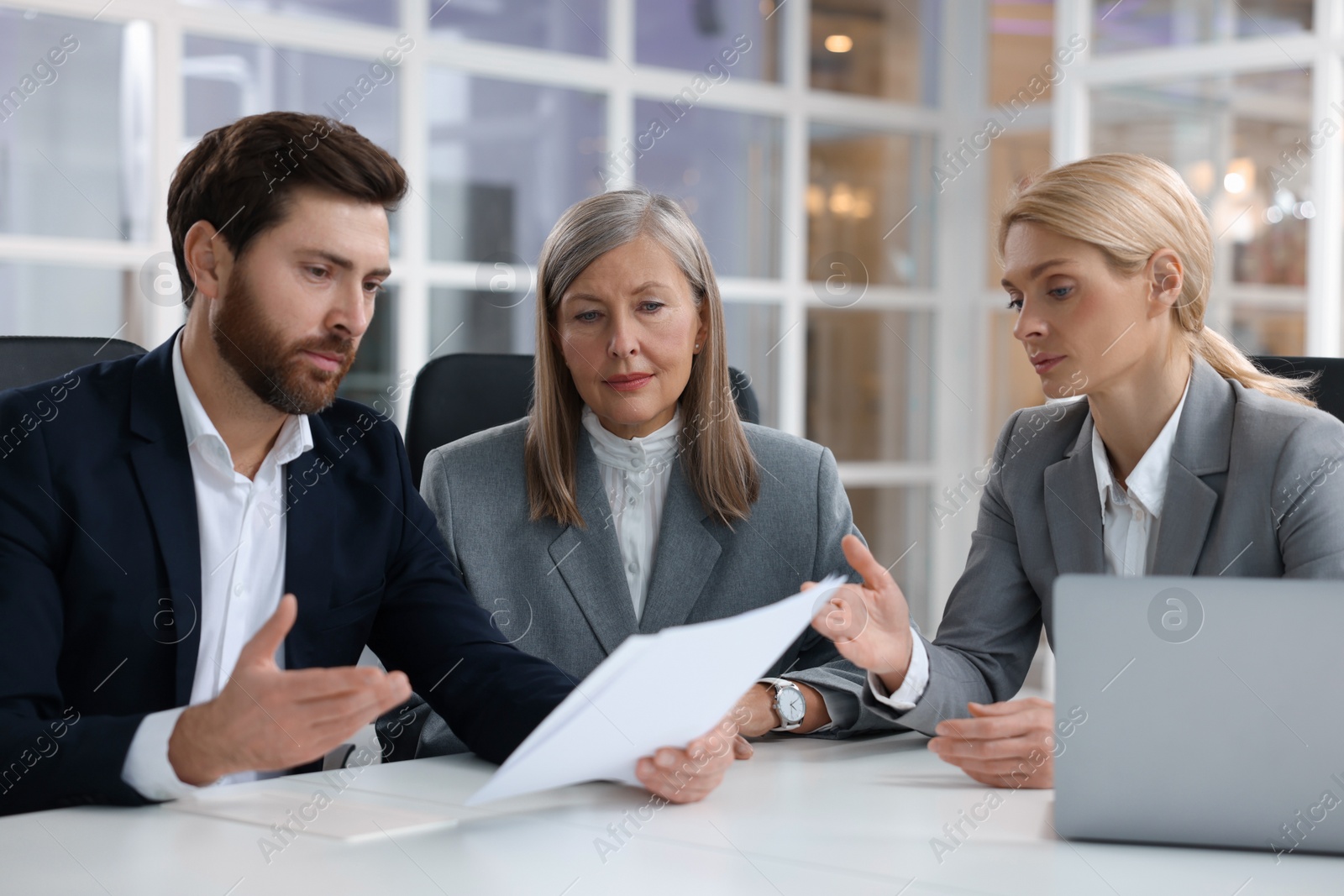 Photo of Lawyers working together at table in office