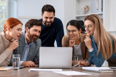 Team of employees working together in office