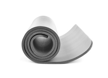 Photo of Rolled grey yoga mat on white background