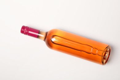 Photo of Bottle of expensive rose wine on white background, top view