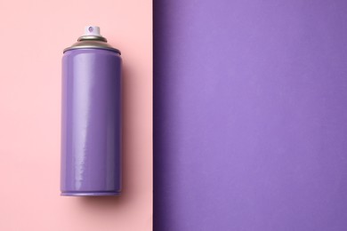 Can of spray paint on color background, top view with space for text. Graffiti supply