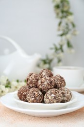 Photo of Delicious sweet chocolate candies on beige table