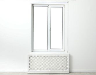Photo of White wall with modern window in empty room