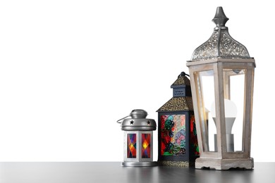 Photo of Decorative Arabic lanterns on grey table against white background