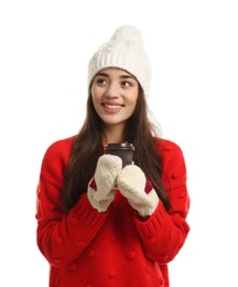 Young woman with cup of hot coffee on white background. Winter season