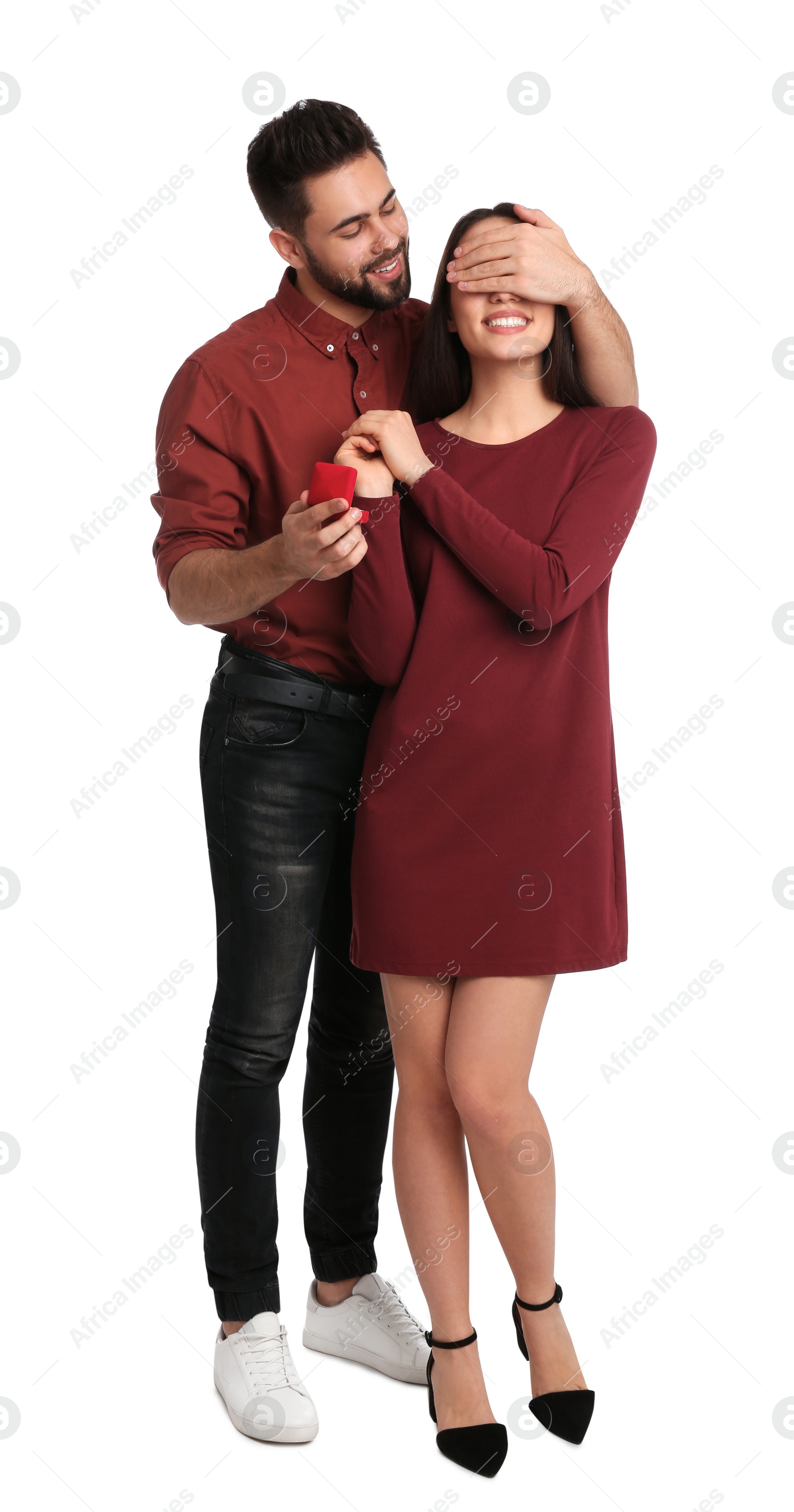 Photo of Man with engagement ring making marriage proposal to girlfriend on white background