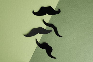 Photo of Fake paper mustaches on color background, flat lay