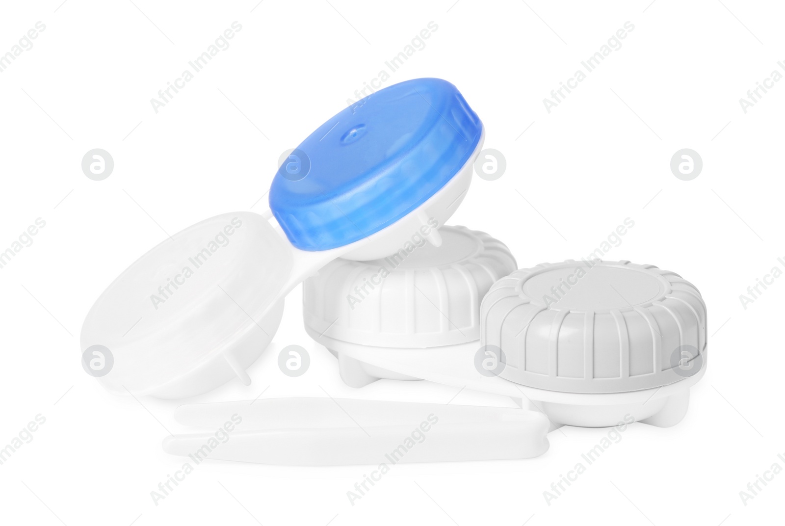 Photo of Cases with color contact lenses and tweezers isolated on white