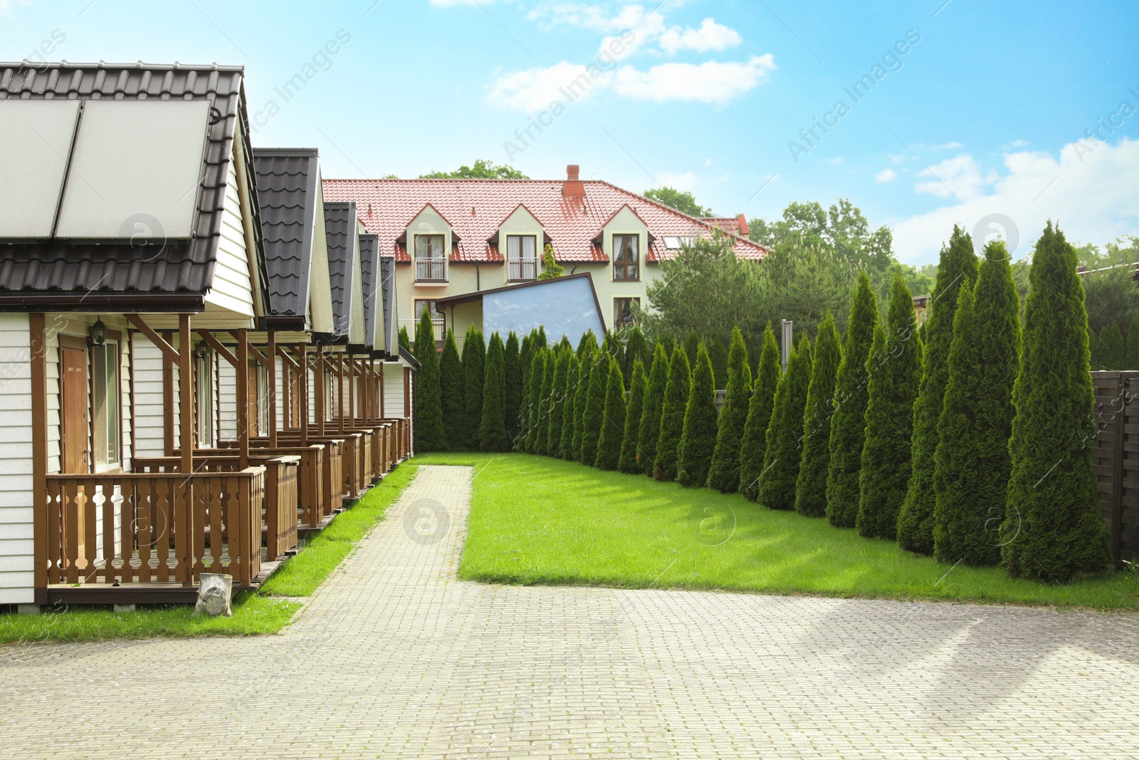 Photo of Beautiful houses and green garden on sunny day