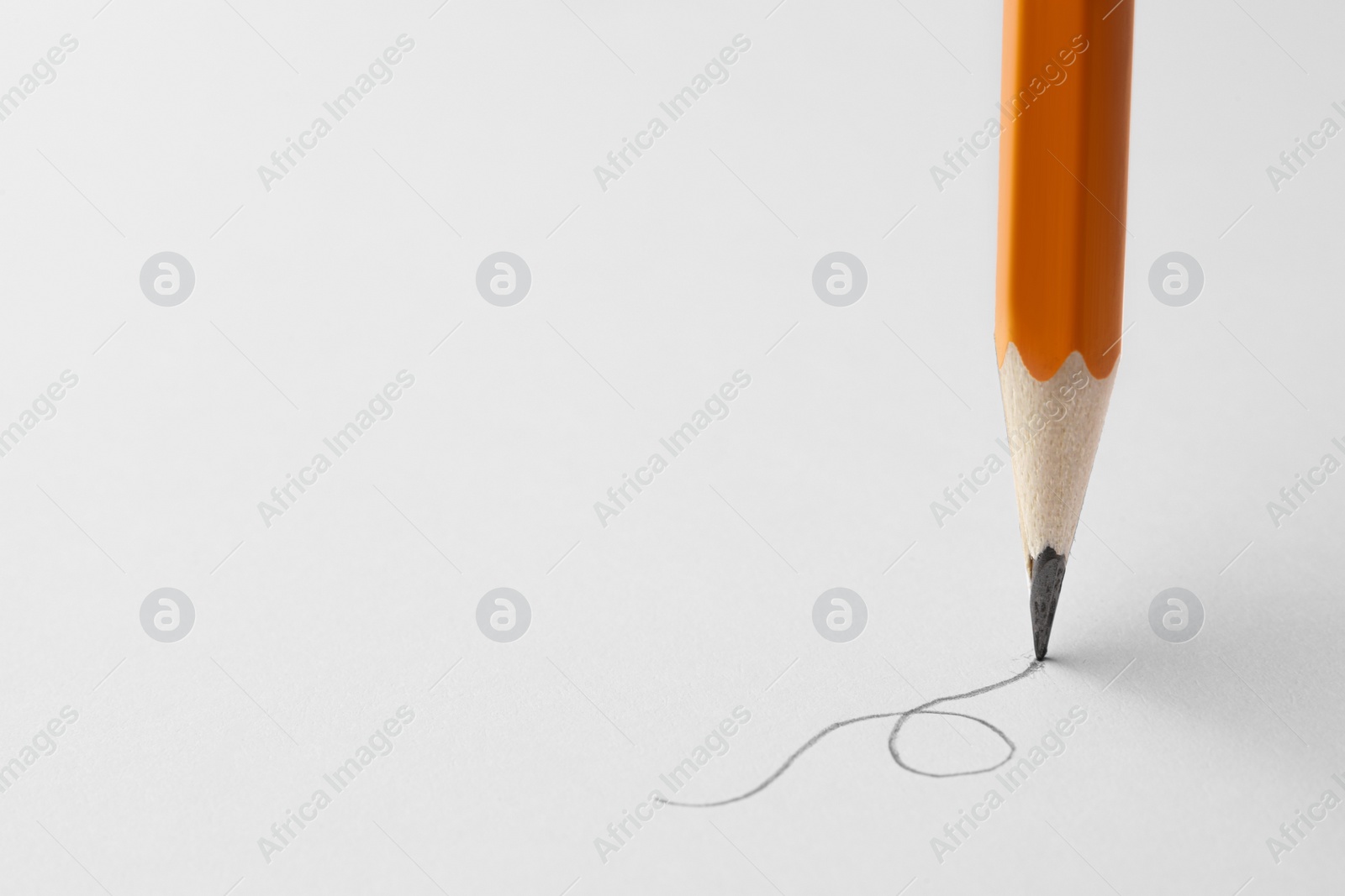 Photo of Drawing with sharp graphite pencil on white sheet of paper, closeup. Space for text