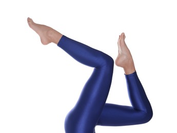 Photo of Woman with beautiful long legs wearing blue leggings on white background, closeup