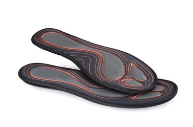 Orthopedic insoles for shoes on white background
