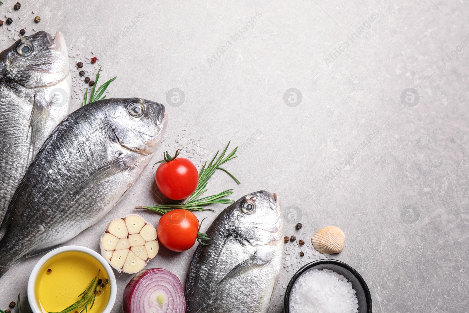 Photo of Flat lay composition with dorada fish on light grey table, space for text