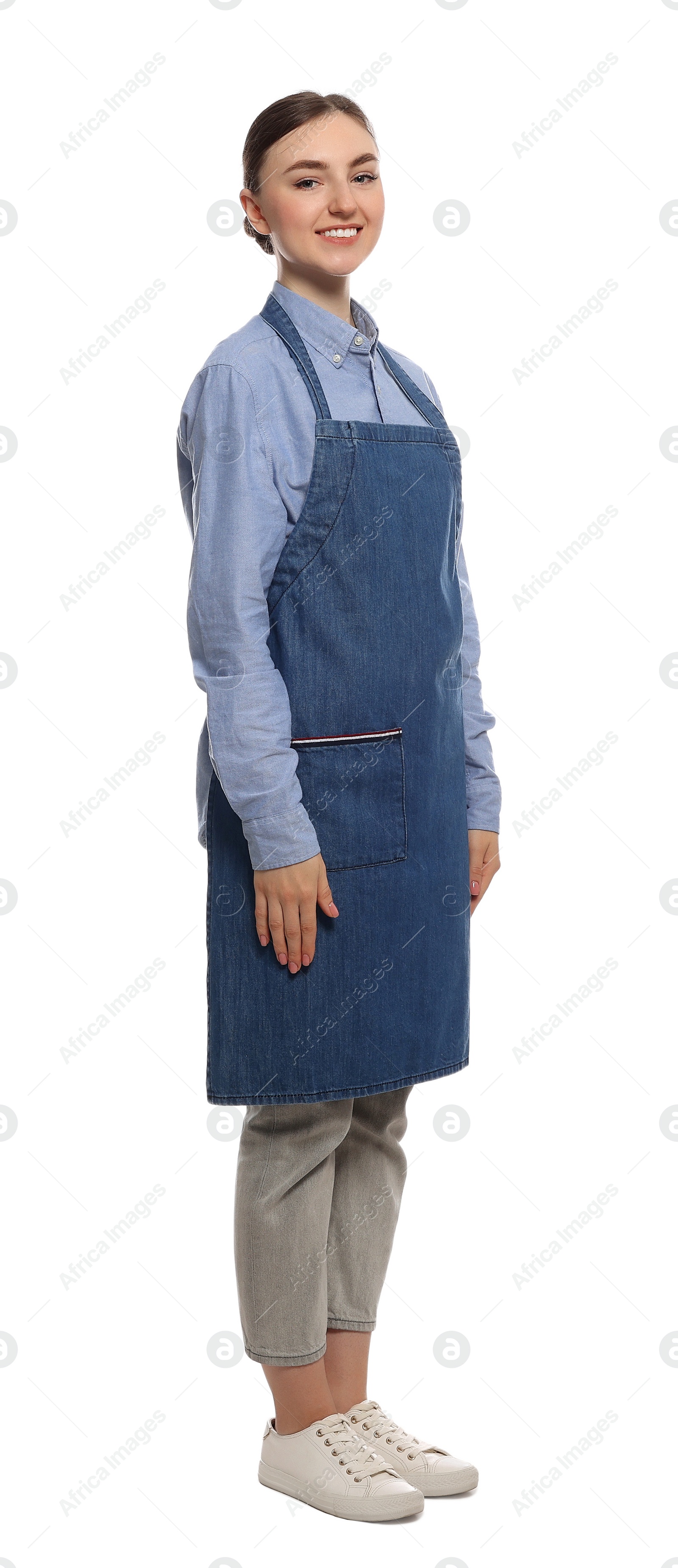 Photo of Beautiful young woman in clean denim apron on white background