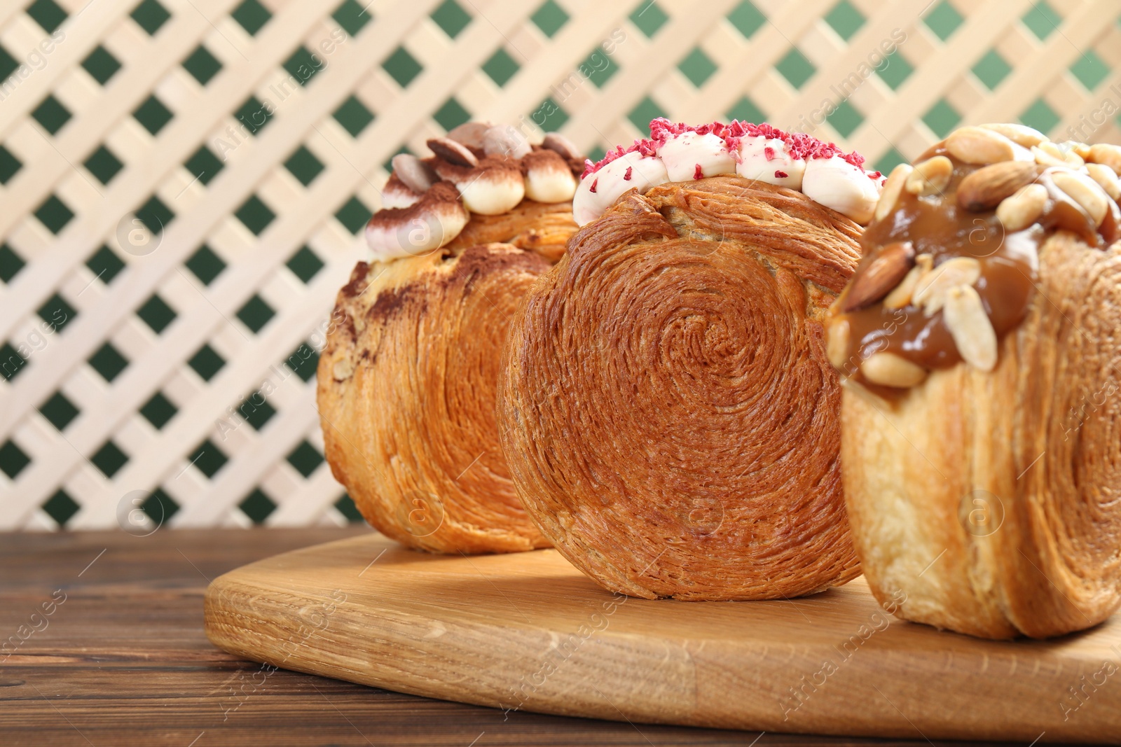 Photo of Tasty puff pastry. Round croissants on wooden table, closeup. Space for text