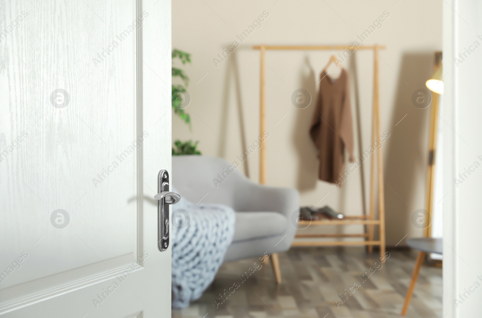 Photo of Stylish room interior, view through open door