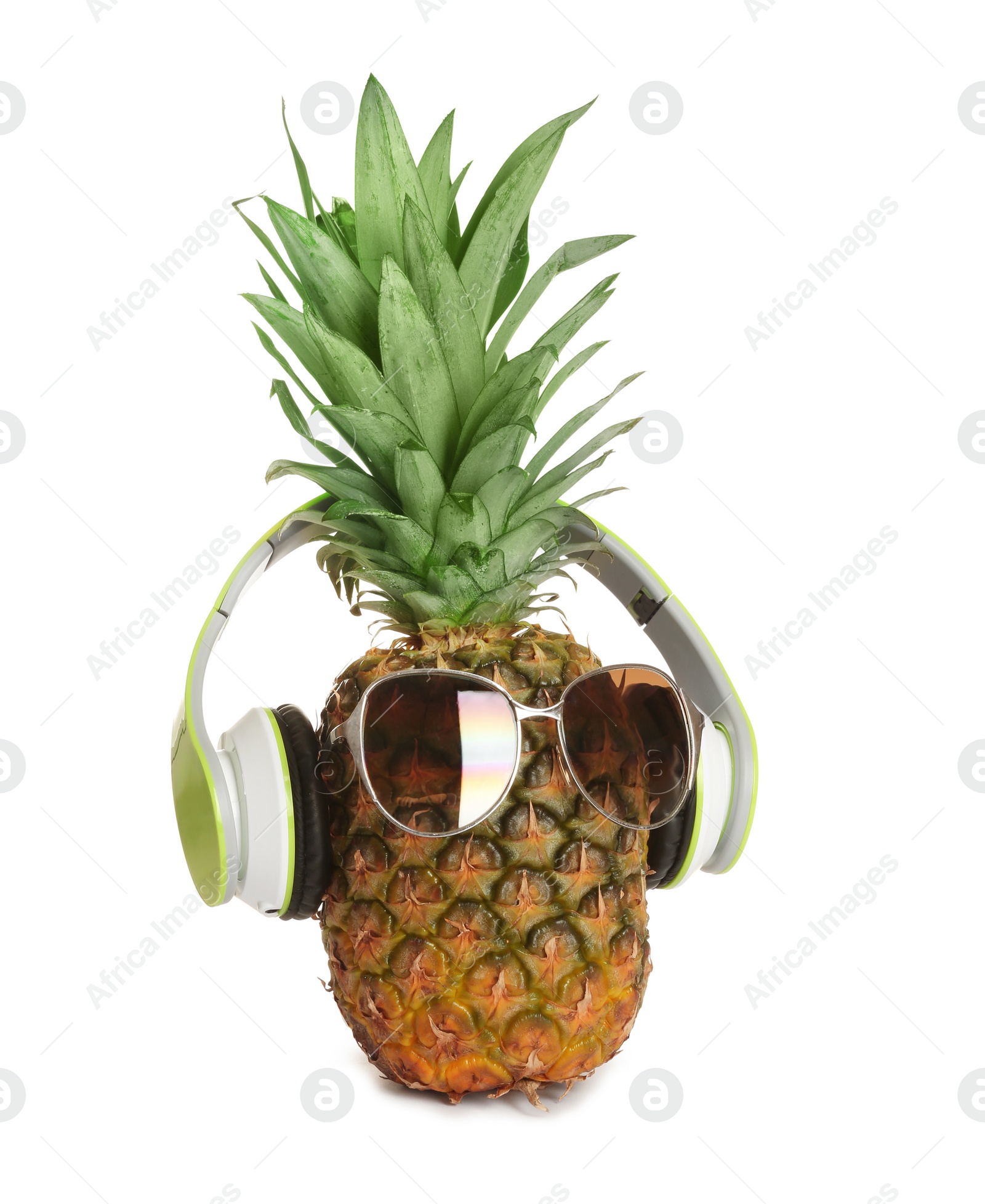 Photo of Funny pineapple with headphones and sunglasses on white background