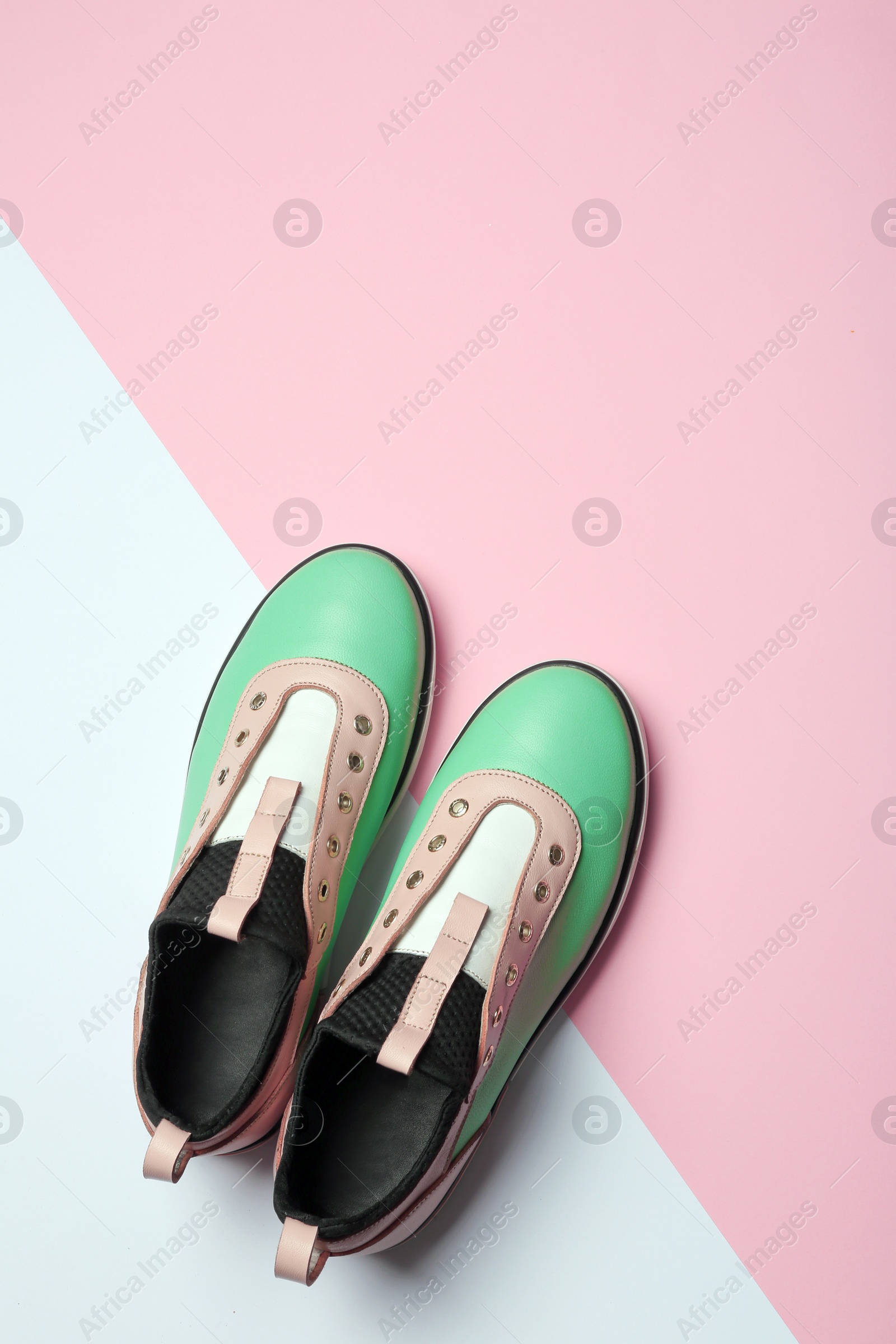 Photo of Flat lay composition of stylish shoes on color background, space for text