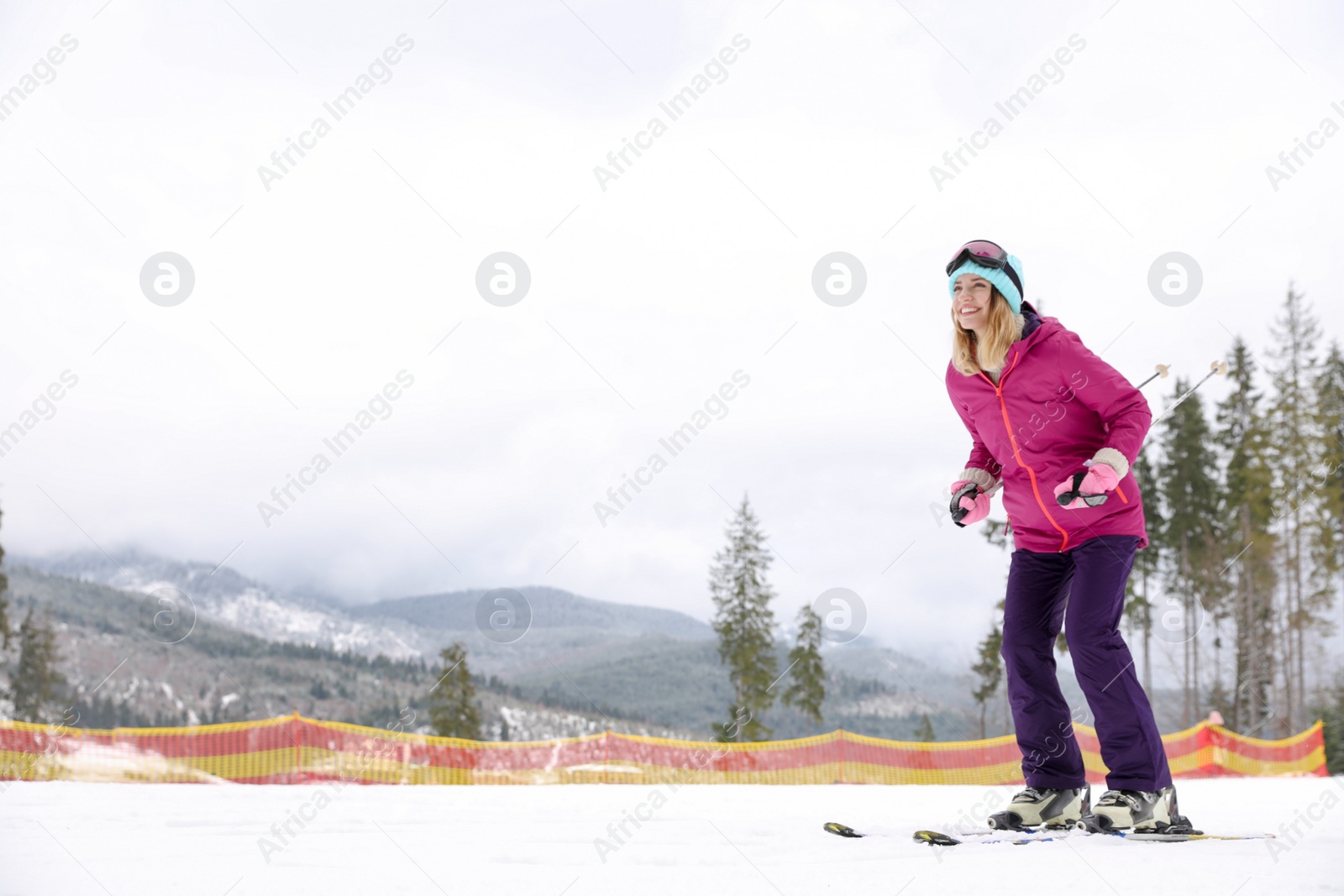 Photo of Female skier on slope at resort, space for text. Winter vacation