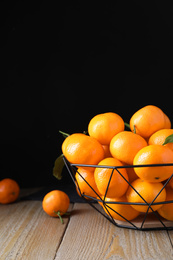 Photo of Tasty fresh ripe tangerines on wooden table