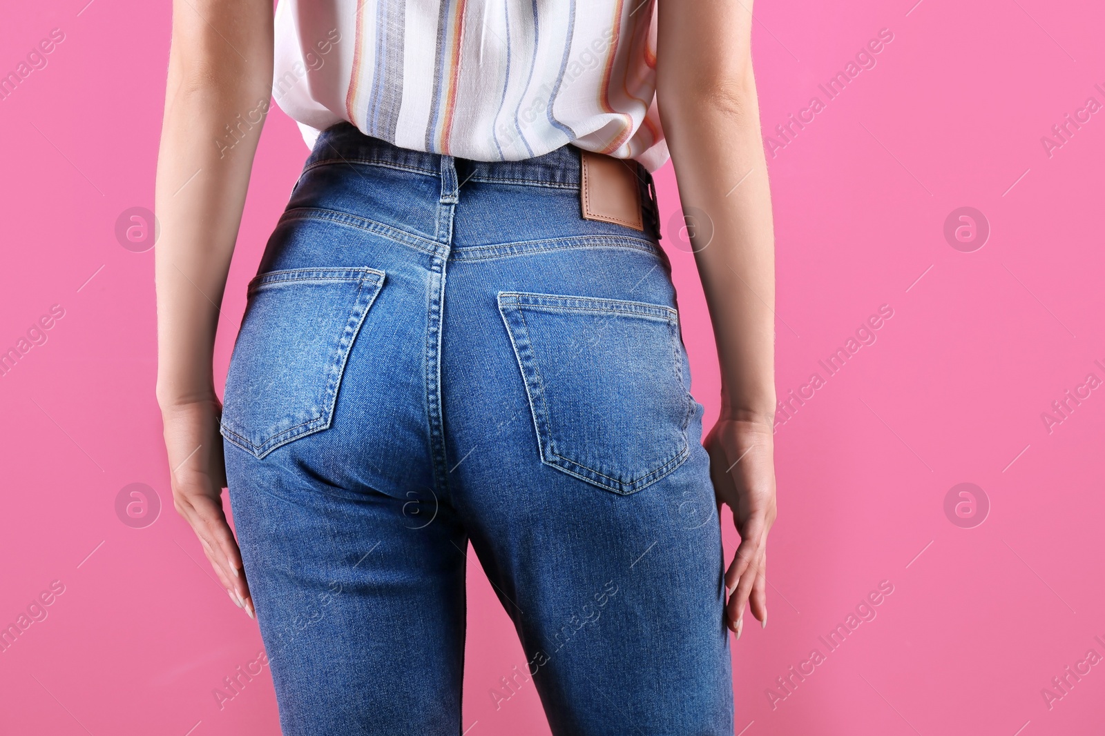 Photo of Woman in stylish blue jeans on color background