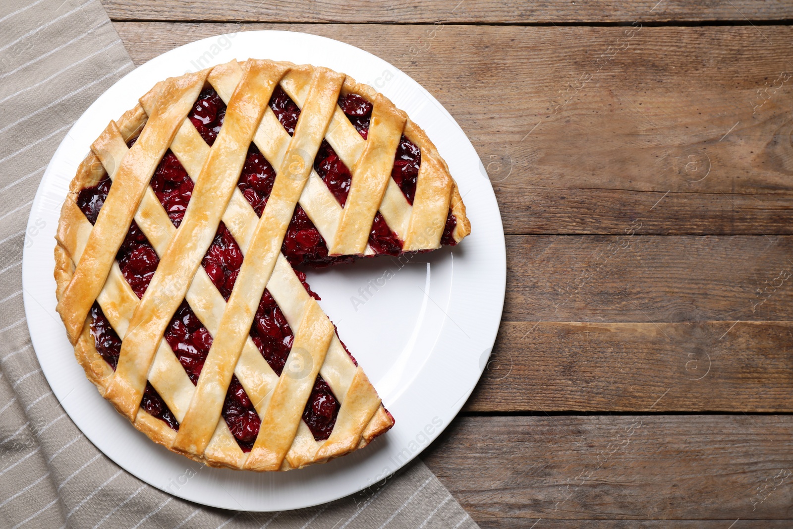 Photo of Delicious fresh cherry pie on wooden table, flat lay