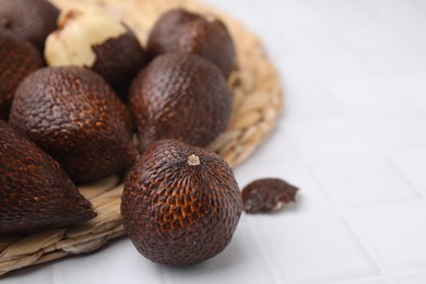 Photo of Fresh salak fruits on white table, closeup. Space for text