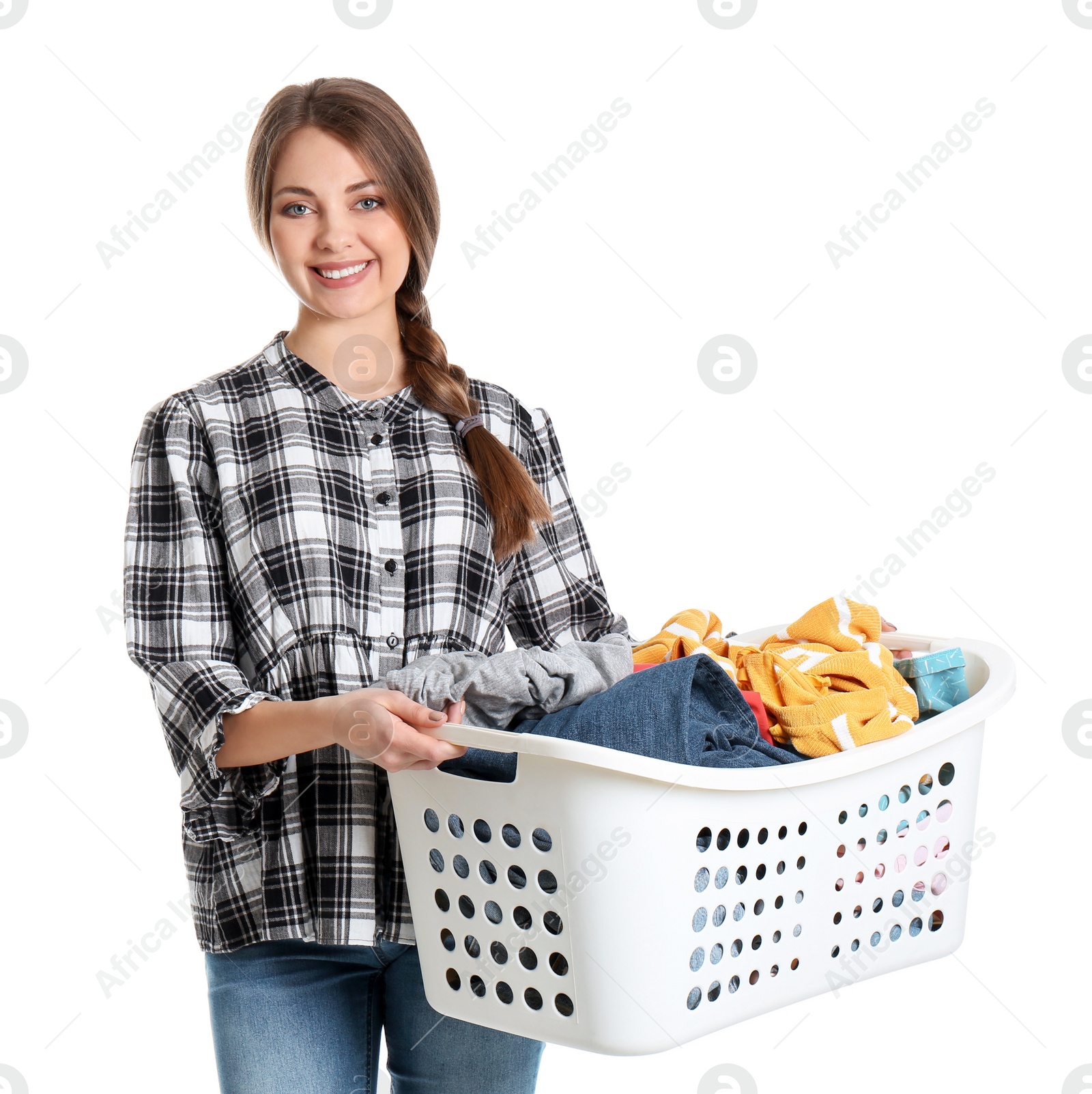 Photo of Happy young woman holding basket with laundry on white background
