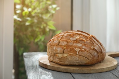 Freshly baked bread with tofu cheese on grey wooden table indoors. Space for text