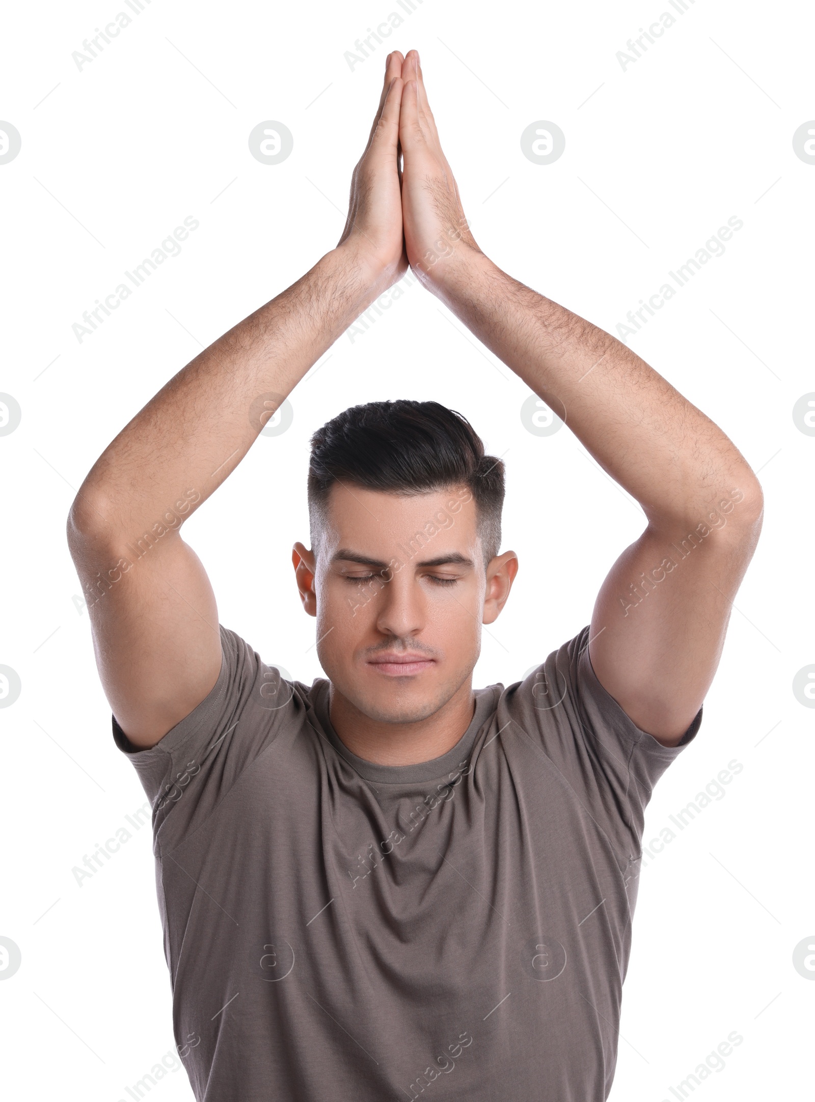 Photo of Handsome man meditating on white background. Harmony and zen