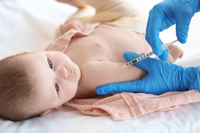 Photo of Doctor vaccinating baby in clinic