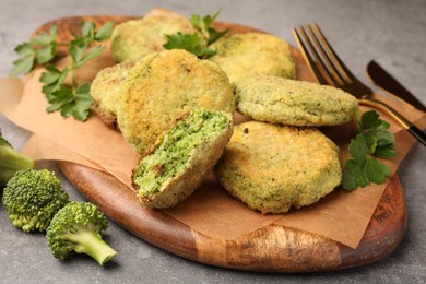 Photo of Delicious vegan cutlets with broccoli and parsley on table, closeup
